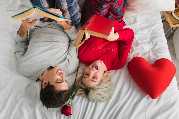 Couple reading in bed on valentines day