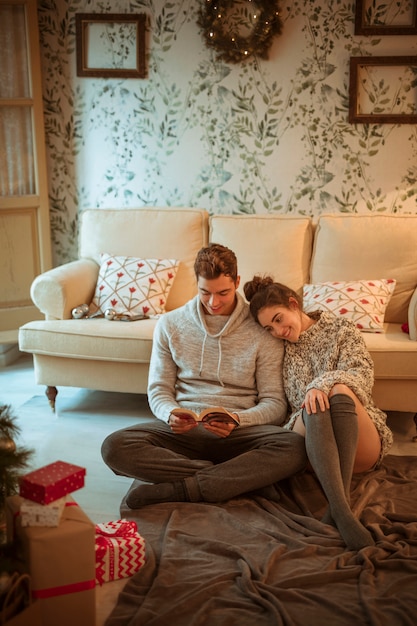 Couple reading book on floor 