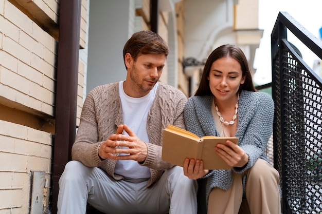 Couple reading outdoors