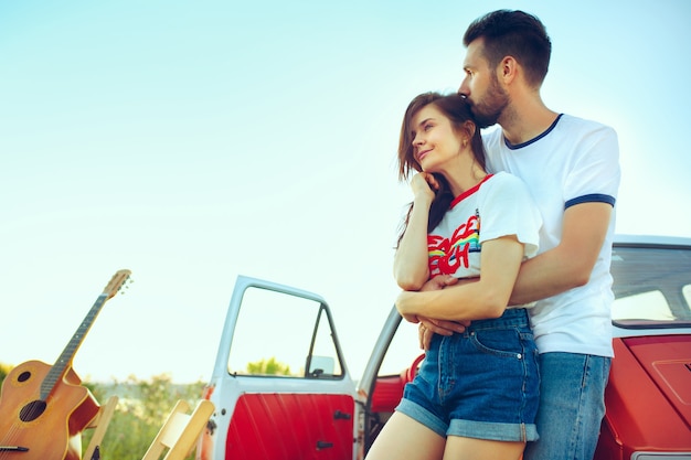 Free photo couple resting on the beach on a summer day near river. caucasian man and woman