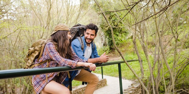 Couple resting on bridge