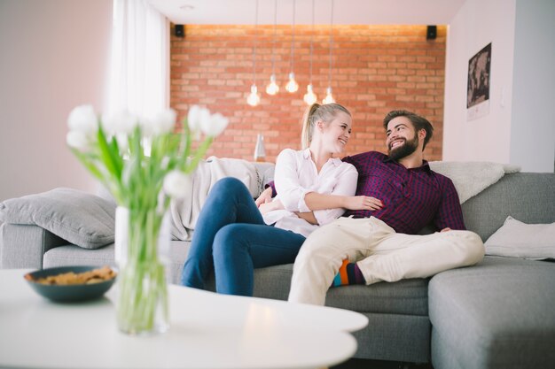 Couple resting on couch