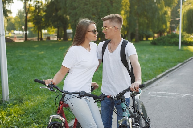 夏の街で自転車に乗るカップル