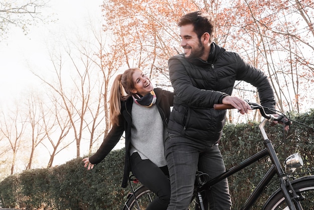 Couple riding cycle in park