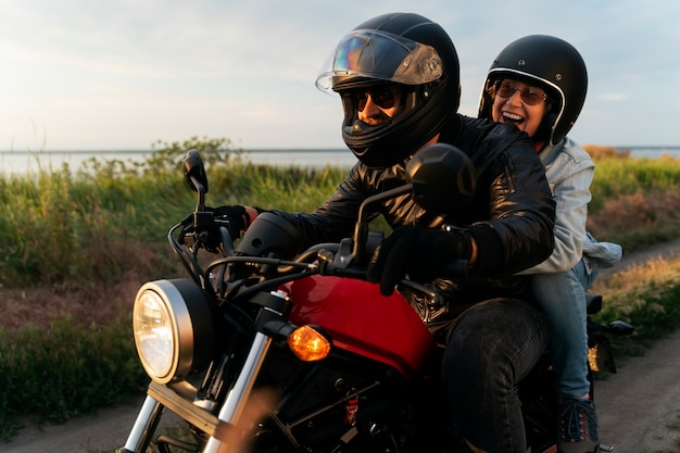 Couple riding a motorbike around beautiful landscape