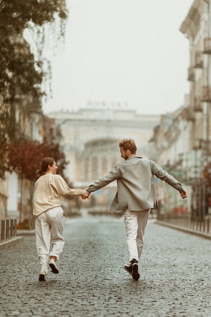 Free photo couple running outdoors full shot