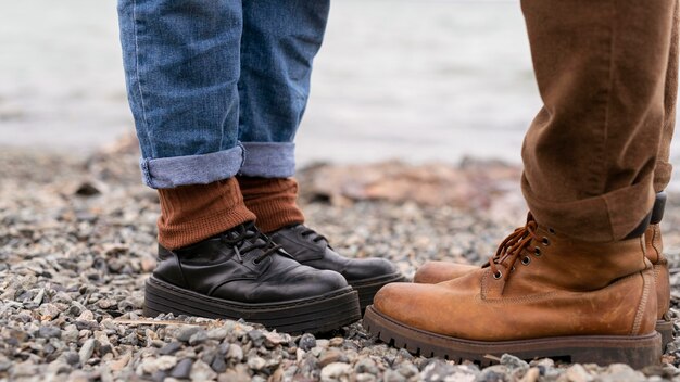 Couple's feet standing on gravel facing eachother