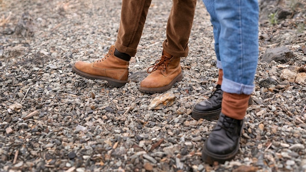 Couple's feet standing on gravel