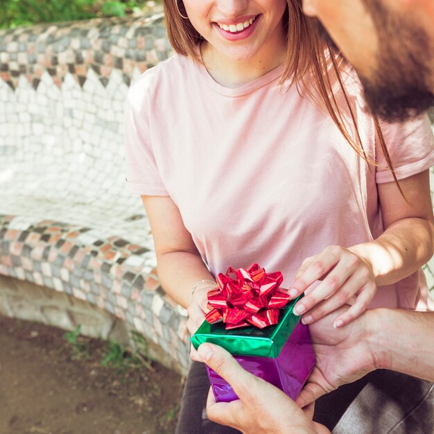 Couple's hand holding gift box