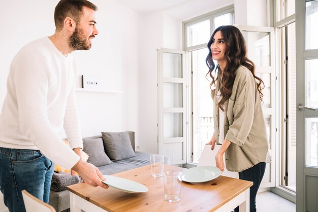 Couple serving table at home