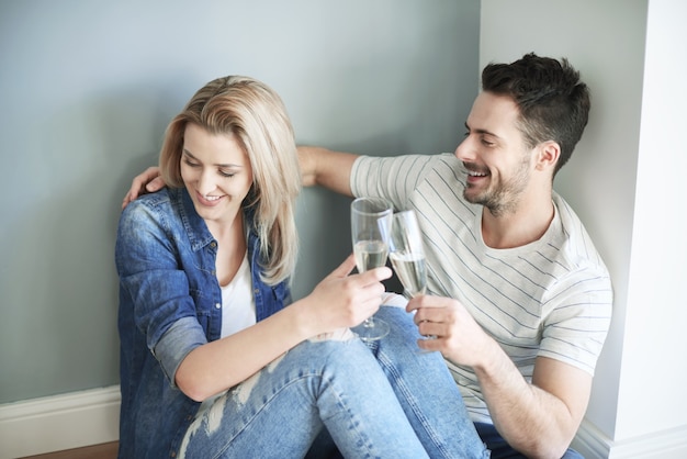 Couple sharing champagne whilst moving