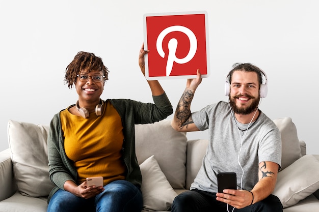 Free photo couple showing a pinterest icon