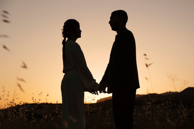 Couple silhouettes in nature side view