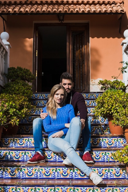 Couple sitting on beautiful stairs outside