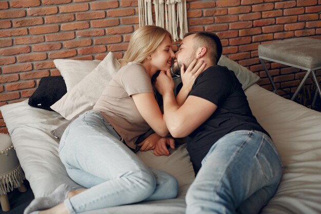 Couple sitting on a bed in a room