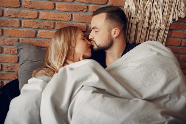 Couple sitting on a bed in a room