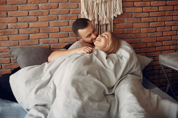 Couple sitting on a bed in a room