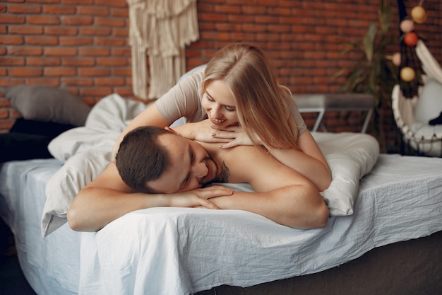 Couple sitting on a bed in a room