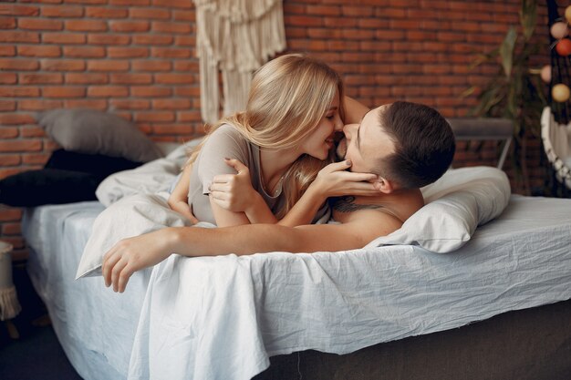 Couple sitting on a bed in a room