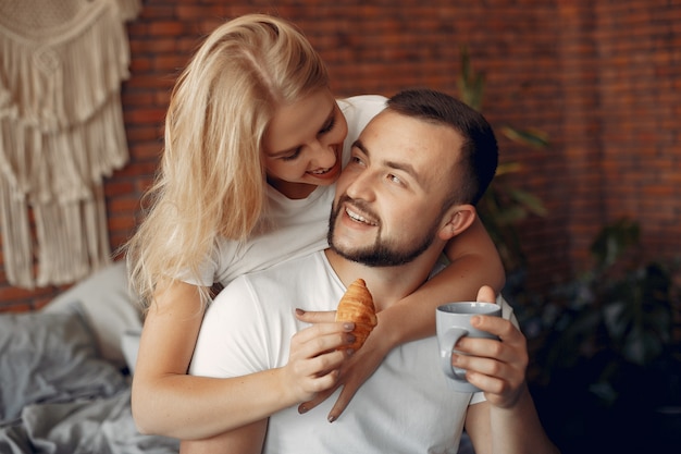 Couple sitting on a bed in a room