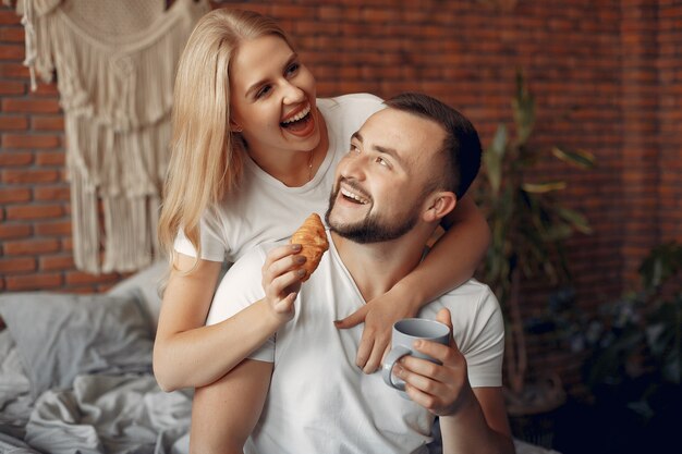 Couple sitting on a bed in a room