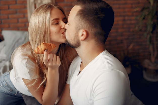 Couple sitting on a bed in a room