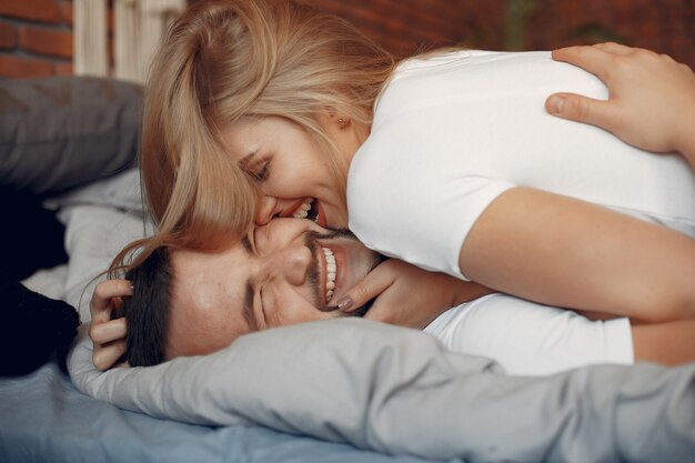 Couple sitting on a bed in a room