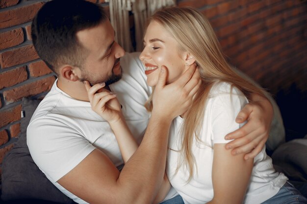 Couple sitting on a bed in a room