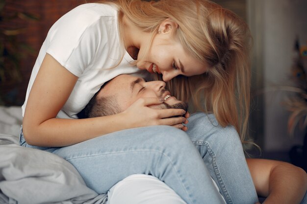 Couple sitting on a bed in a room