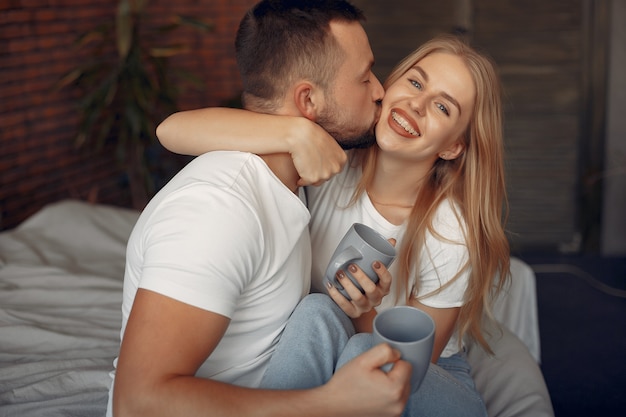 Couple sitting on a bed in a room