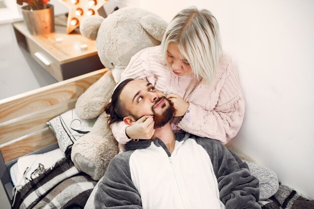 Couple sitting on a bed in a room