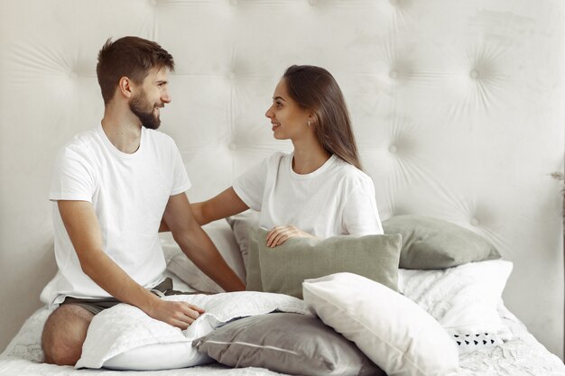 Couple sitting on a bed in a room