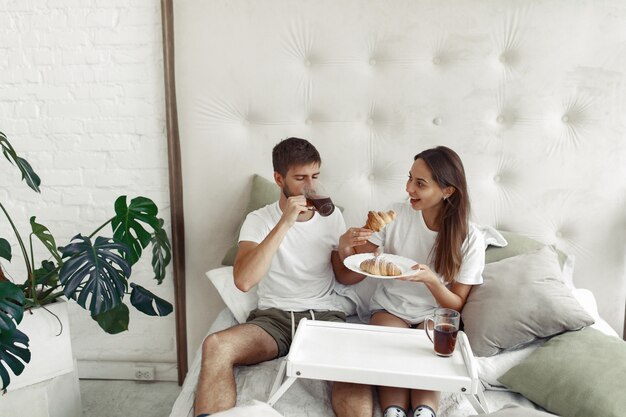 Couple sitting on a bed in a room