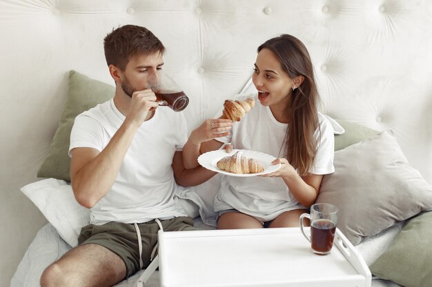 Couple sitting on a bed in a room