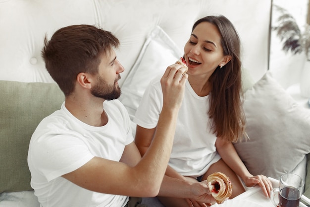 Couple sitting on a bed in a room