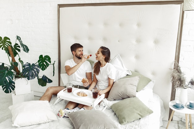 Couple sitting on a bed in a room