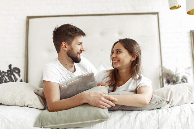 Couple sitting on a bed in a room