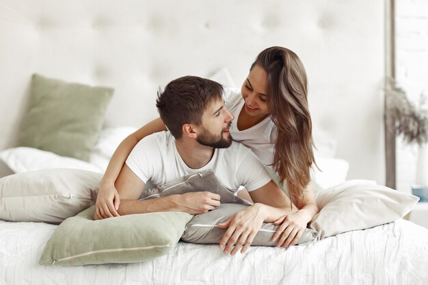 Couple sitting on a bed in a room