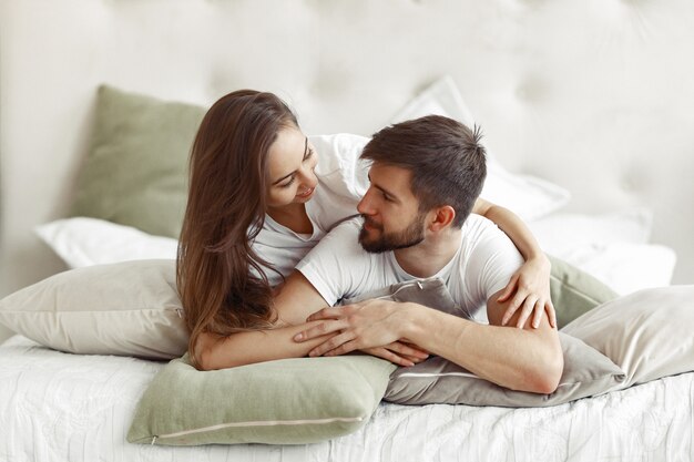 Couple sitting on a bed in a room