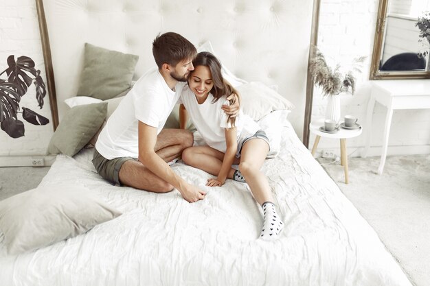 Couple sitting on a bed in a room