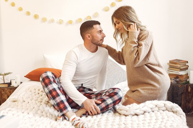 Couple sitting on a bed in a room