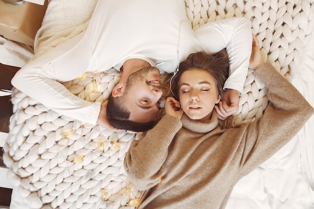 Couple sitting on a bed in a room
