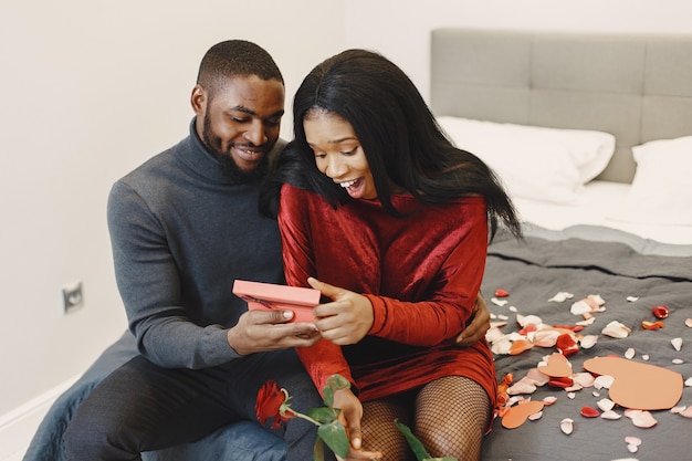 Couple sitting on a bed on Valentine's Day