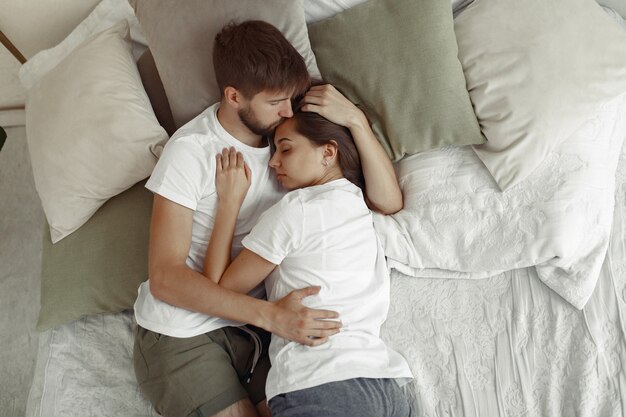 Couple sitting on a bed