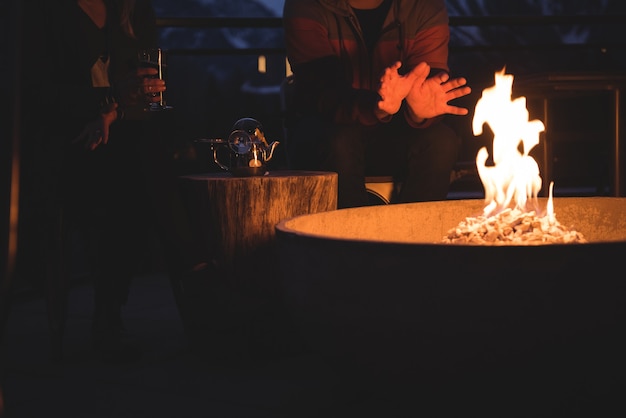 Couple sitting by fire pit