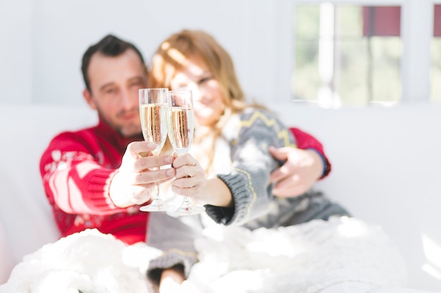 Couple sitting and clinking glasses