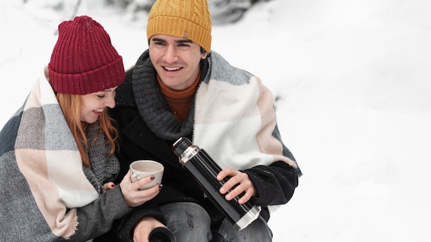 Free photo couple sitting and drinking hot beverages high view