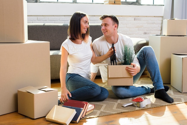 Couple sitting on the floor looking at each other