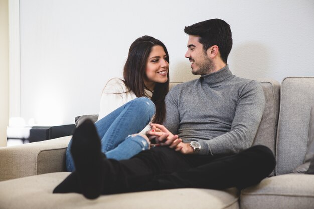 Couple sitting on a gray couch