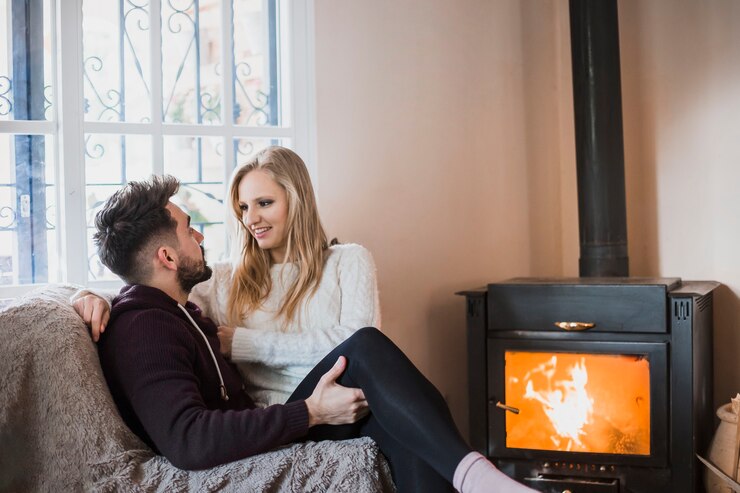 Free Photo couple sitting near fireplace